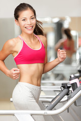 Wall Mural - Woman running on treadmill gym