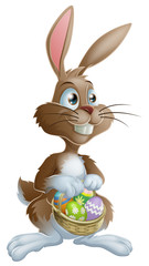 Wall Mural - Easter bunny rabbit holding Easter eggs basket