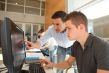 Fototapeta  - Teacher and student working on computer