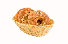 A Variety Of Different Kind Of Bagels In A Small Basket