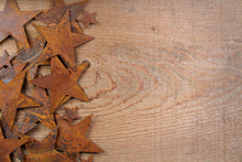 Rusty Stars On A Wooden Background