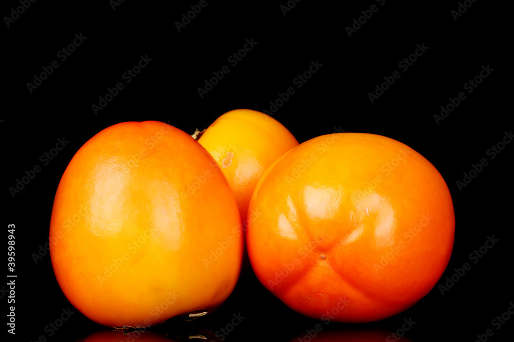 Appetizing persimmons isolated on black