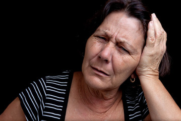 Aged woman suffering from a strong headache