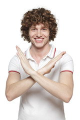 Wall Mural - Smiling male making stop sign on white background