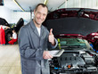 Master mechanic in a garage shows thumb up for good service