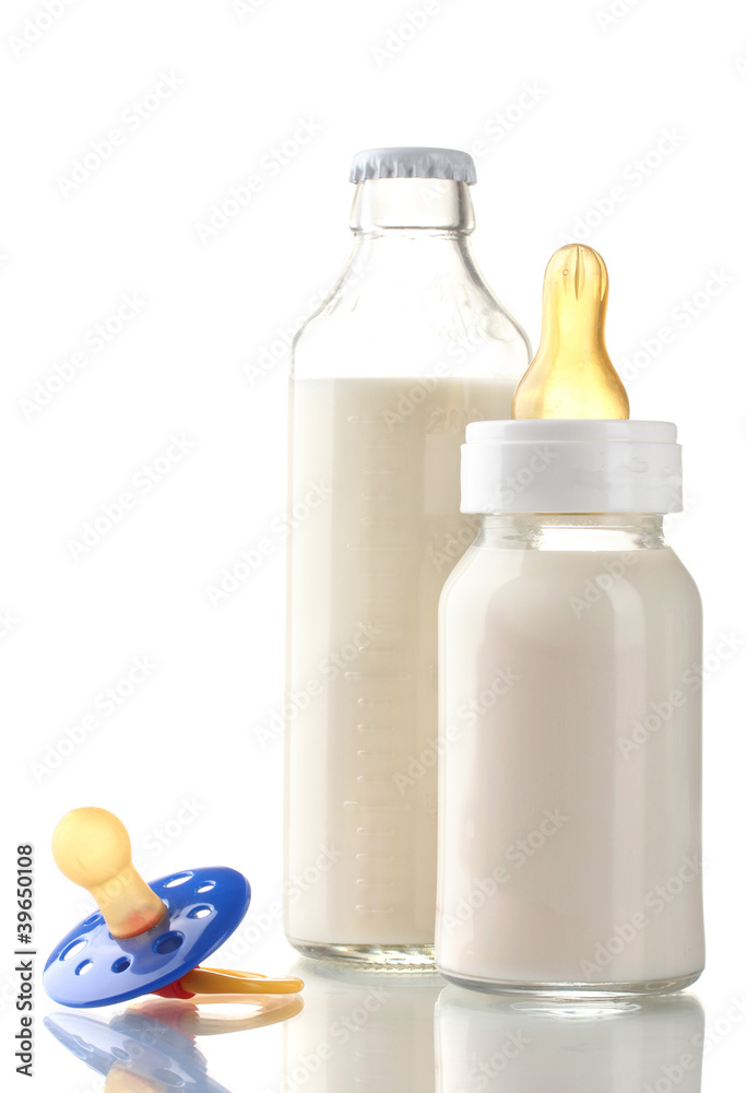 bottles of milk and soother isolated on white