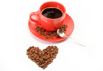 Heart made ​​from coffee beans around a cup of coffee on a w