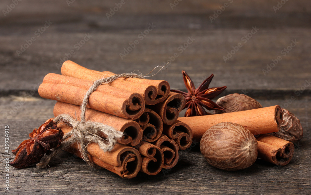 Cinnamon sticks, nutmeg and anise on wooden table