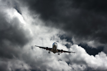 Poster - Passenger plane against stormy sky