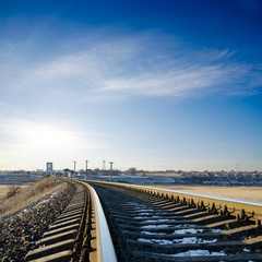 Wall Mural - railroad to horizon under deep blue sky in sunset