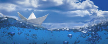Paper Ship Splash With Bubbles Sailing In Blue Water And Sky