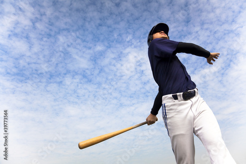 Fotografie, Obraz baseball player taking a swing with cloud background
