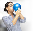 woman blowing balloon