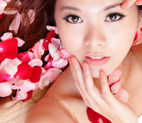 Girl smiling and touch face with red rose