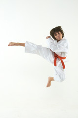 Wall Mural - boy practicing karate on white background