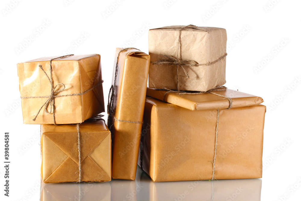 Many parcels wrapped in brown paper tied with twine isolated