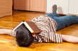 © Solid photos - Teenage boy sleeping on the floor with book covering his face