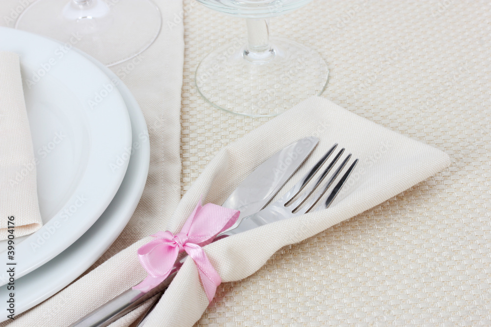 Table setting with fork, knife, plates, and napkin