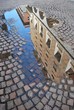 Ancient palaces reflecting in a puddle, Novara, Piedmont, Italy