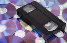 CD Vs VHS. VHS Cassette Lay On The Many CD Disks