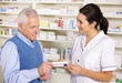 © Monkey Business - American pharmacist serving  senior man in pharmacy