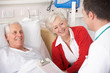 © Monkey Business - Doctor talking to senior couple on USA Hospital ward