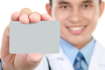 Canvas Print - Young doctor holding business blank card