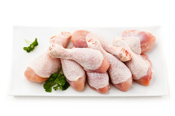 Raw chicken legs on white background