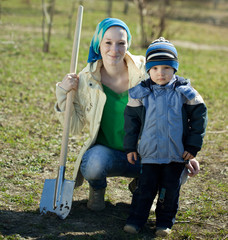 woman and boy  with spade