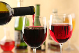 Fototapeta Storczyk - Pouring red wine into glasses
