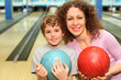 © Pavel Losevsky - beautiful young mother and son keep balls in bowling club