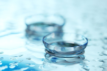 contact lens with drops on blue background