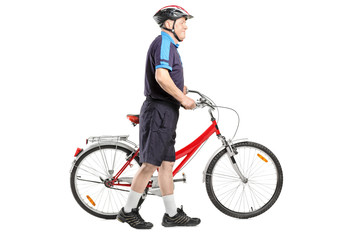 Poster - Full length portrait of a senior bicyclist pushing a bicycle