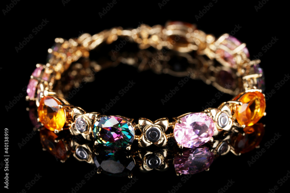Beautiful bracelet with precious stones on black background