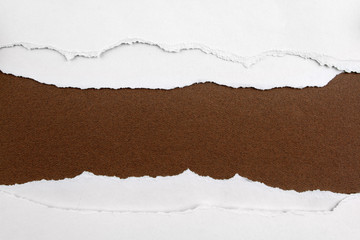 Ripped white paper on brown background