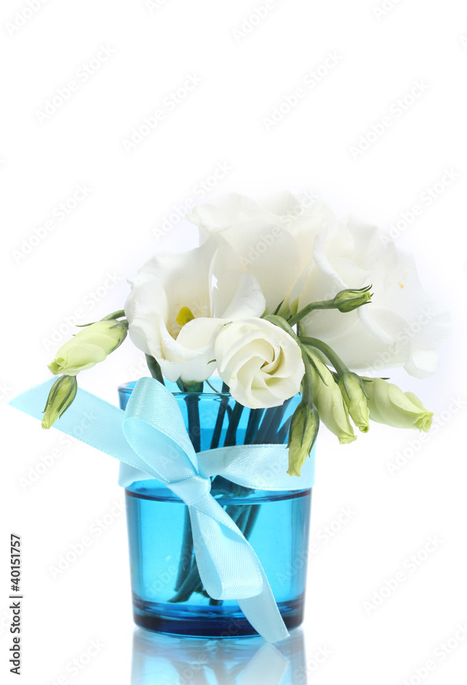 beautiful spring flowers in blue vase isolated on white