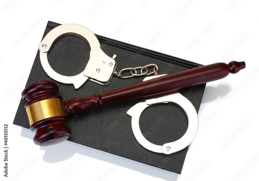 wooden gavel, handcuffs and book isolated on white
