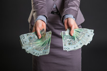 Woman With Polish Zloty Money On Dark Gray Background