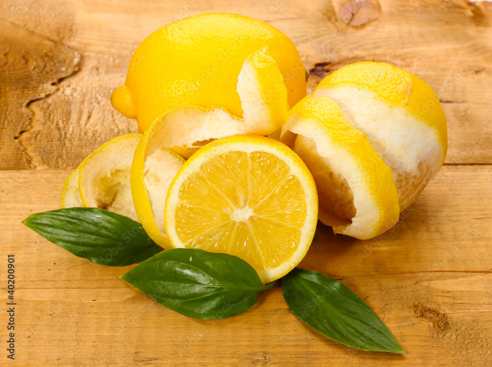 ripe lemons with leaves on wooden table