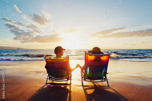 Fototapeta na wymiar Happy Romantic Couple Enjoying Beautiful Sunset at the Beach