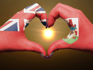 Heart and love gesture by hands colored in bermuda flag during b