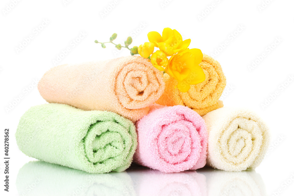 colorful towels and flowers isolated on white