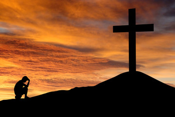 Wall Mural - Silhouette of a man sitting regretting his sins