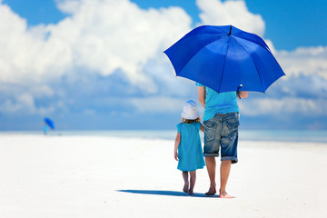 Wall Mural - Father and daughter walking at beach