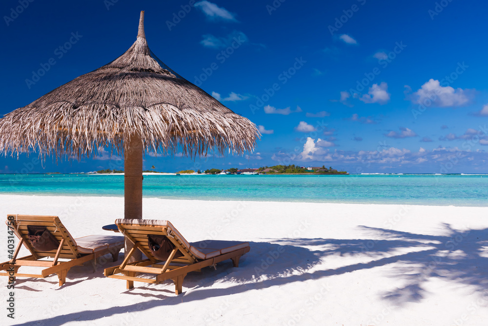 Foto-PVC Boden - Chairs and umbrella on a beach with shadow from palm tree
