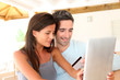 © goodluz - Couple at home doing online shopping with tablet
