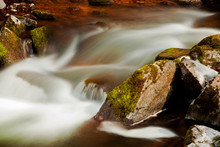 Flowing River Blurred Through Rocks