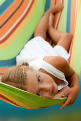 Wall Mural - Summer vacation - Lovely  girl resting in colorful hammock