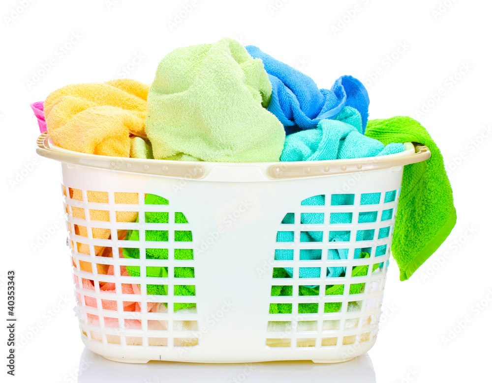 Plastic basket with bright towels isolated on white