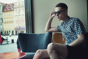 Elegant young man sitting in a bar